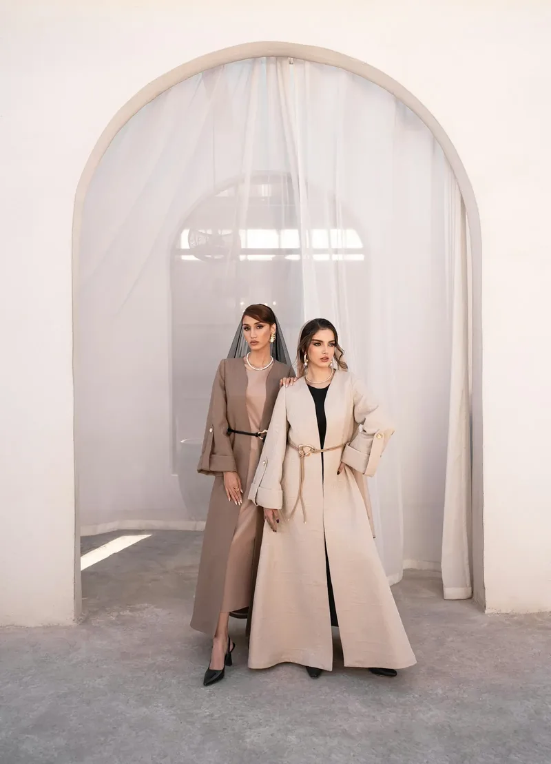 Two abayas shown indoors